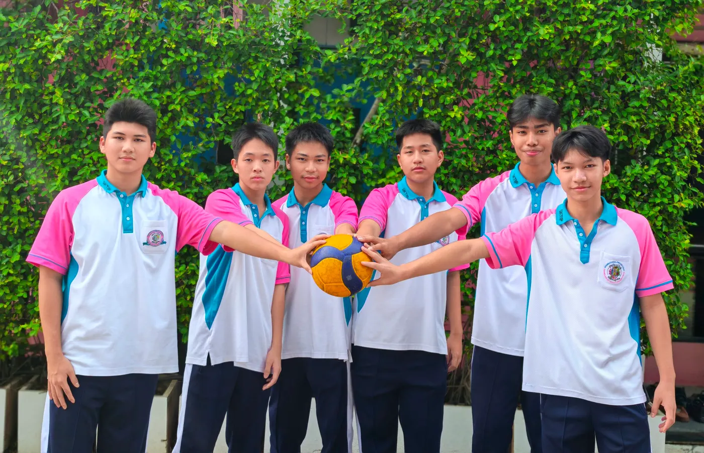 SKTIP students in sports uniform holding a volleyball