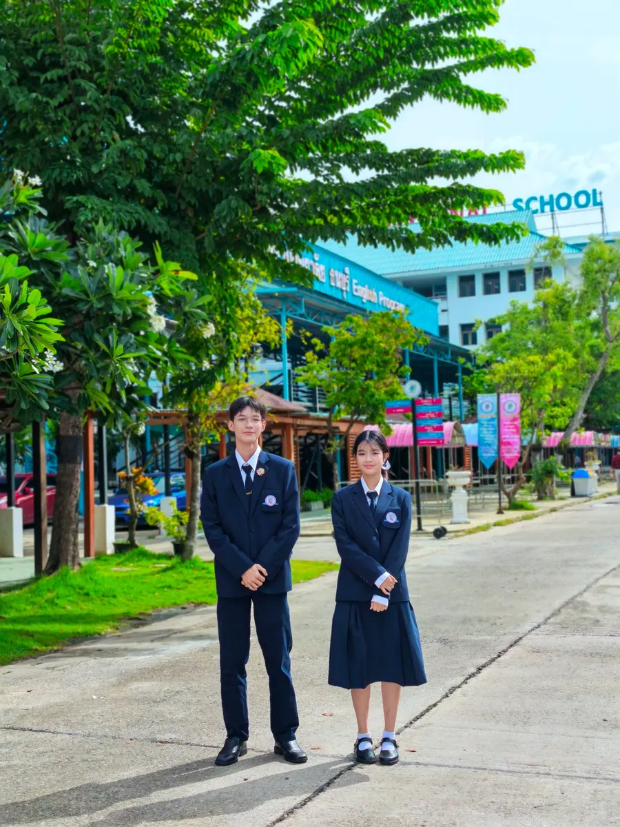 Two SKTIP students in school uniform on campus